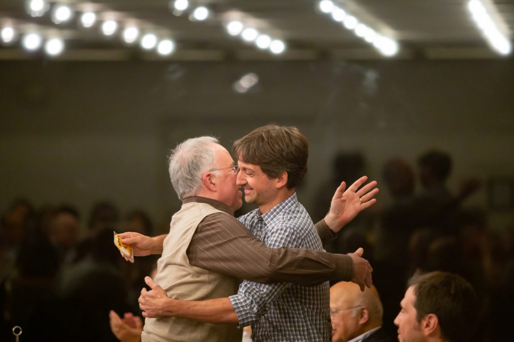 Grossman hugs Princeton Professor Eduardo Morales following Morales' comments about Grossman's influence at Princeton